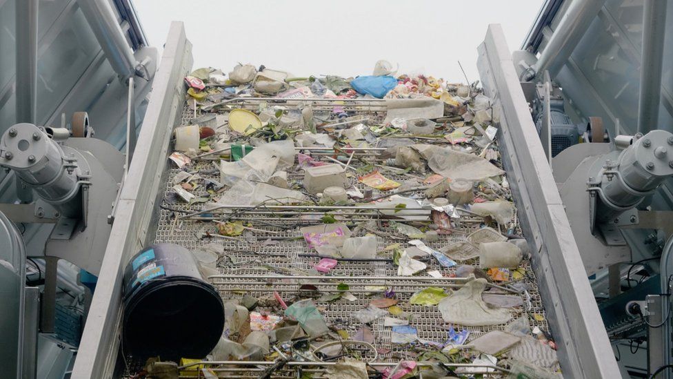 Plastic rubbish gathered by an Interceptor moving along a conveyor belt