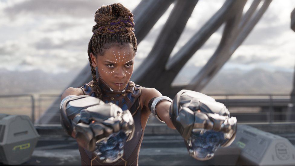 Shuri from Black Panther with big guns on her hands