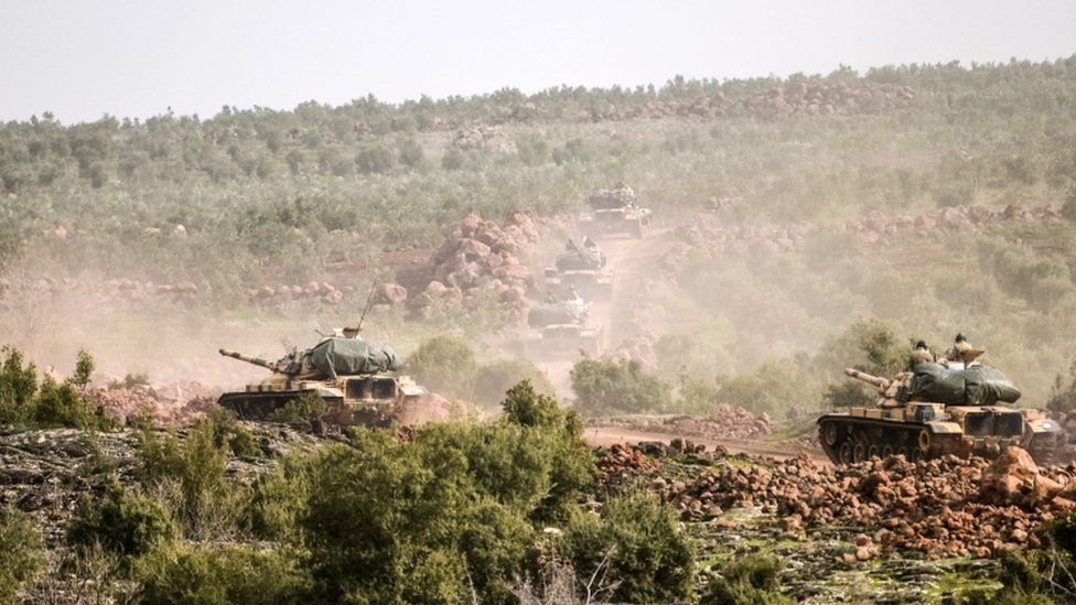 Turkish troops advance near Syrian border throw bush landscape