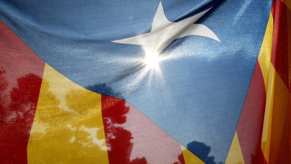 An estelada (Catalan separatist flag) flies in front of Catalonia's parliament