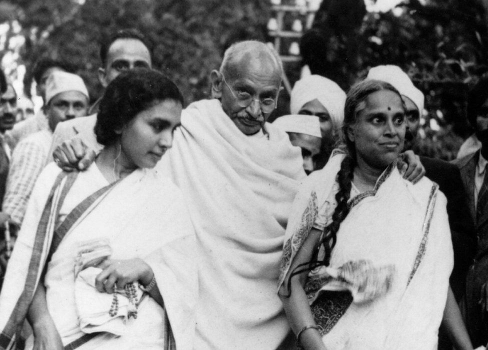 Gandhi leaves his Simla residence helped by his associate Sushila Be (L) and his doctor, Sheila Nayar (R).