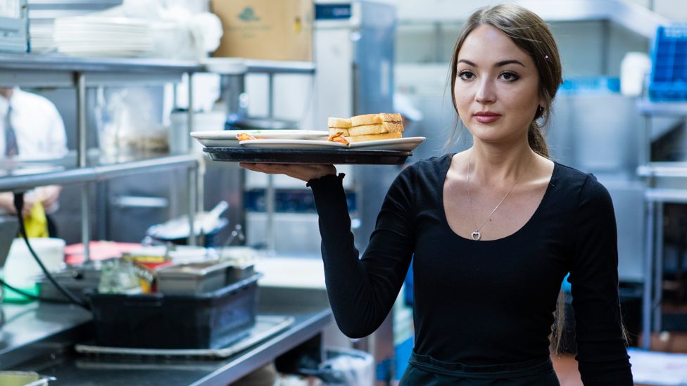 Waitress holding plate