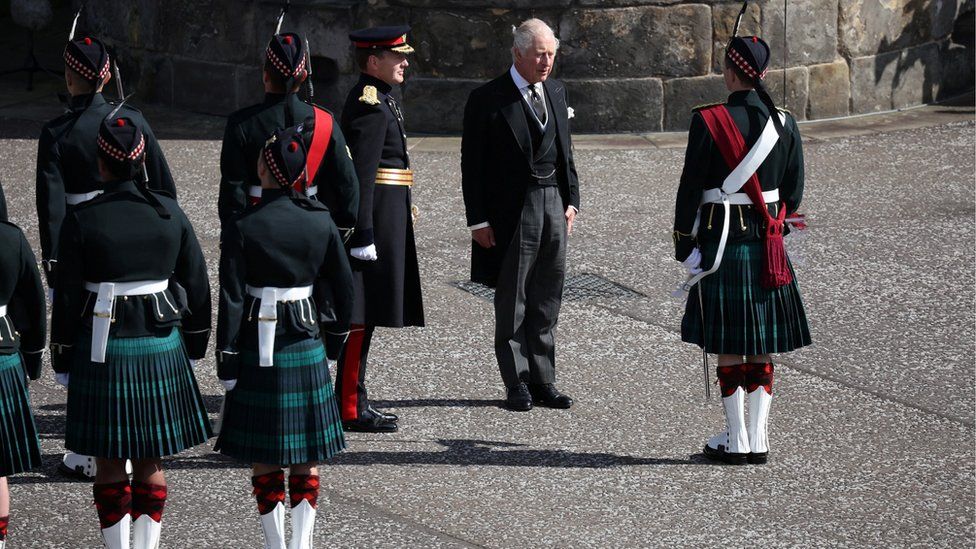 King Charles inspects an honour guard at the Palace of Holyroodhouse