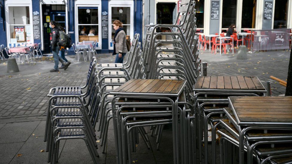 chairs piled up outside cafe