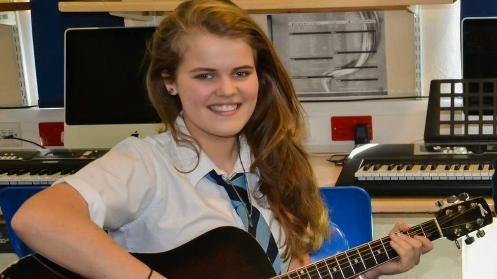 Daisy Clark with her guitar at school