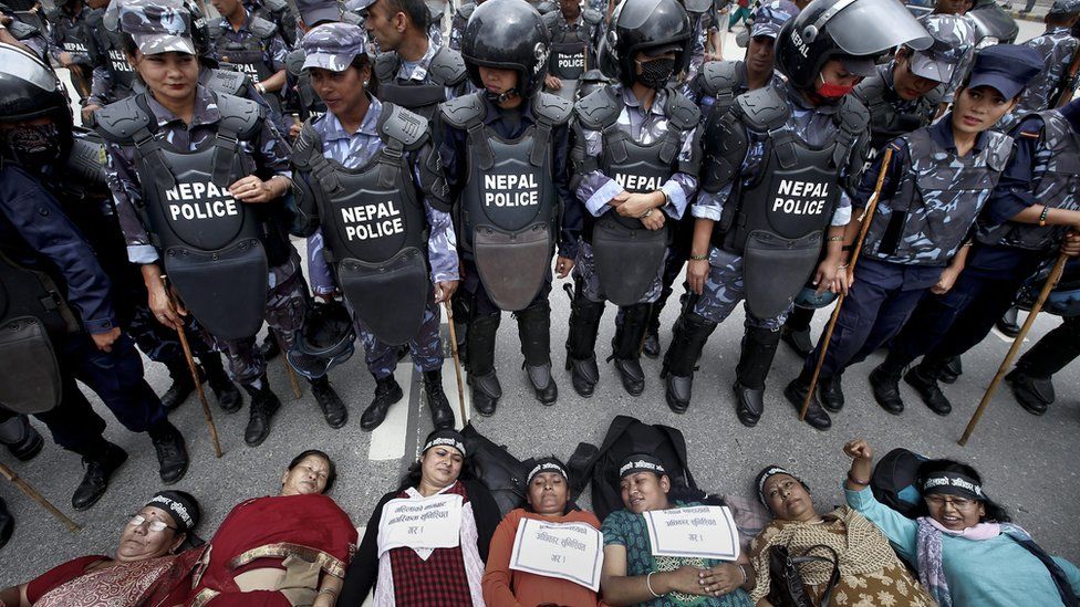 Nepalese women activists lie down on a road during a protest demanding women rights in upcoming constitution in Kathmandu, Nepal, 07 August 2015