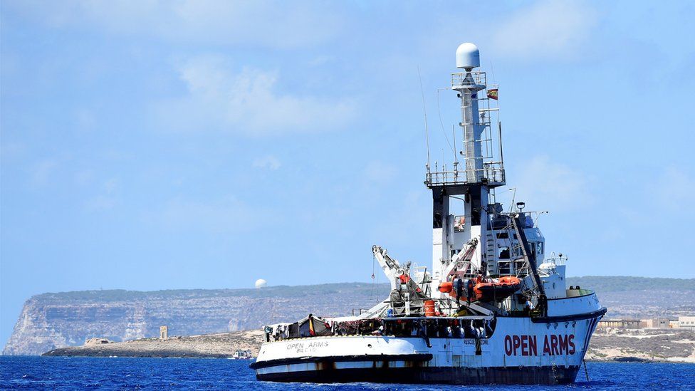 Spanish migrant rescue ship Open Arms is seen in front of the "Door to Europe" monument, close to the Italian shore in Lampedusa