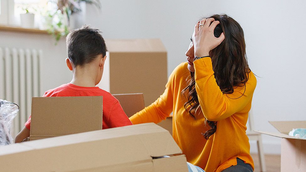 Woman packing moving boxes
