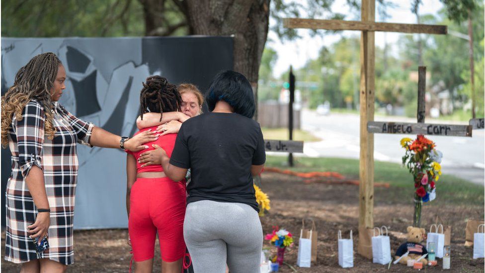 People pay tribute to those killed in the Dollar General store shooting