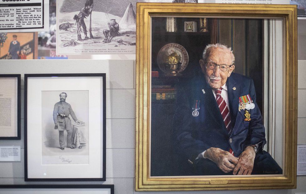 The portrait of Captain Sir Tom Moore by artist Alex Chamberlin hangs on a wall