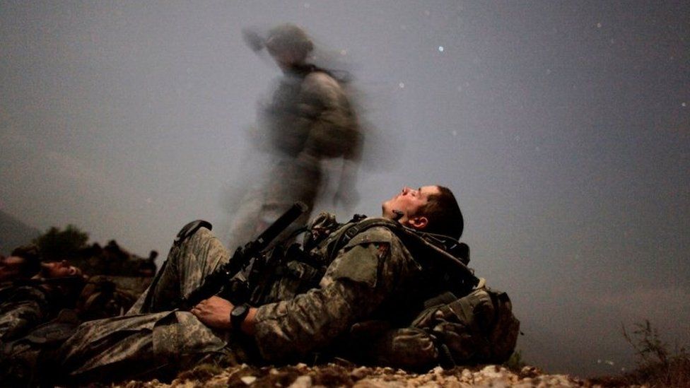 A US soldier rests during a night mission in Kunar province
