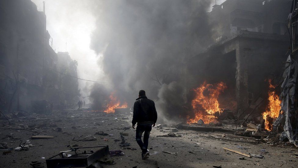 A man inspects a site hit by what activists said were airstrikes by forces loyal to Syria"s President Bashar al-Assad, in the Douma neighborhood of Damascus, Syria