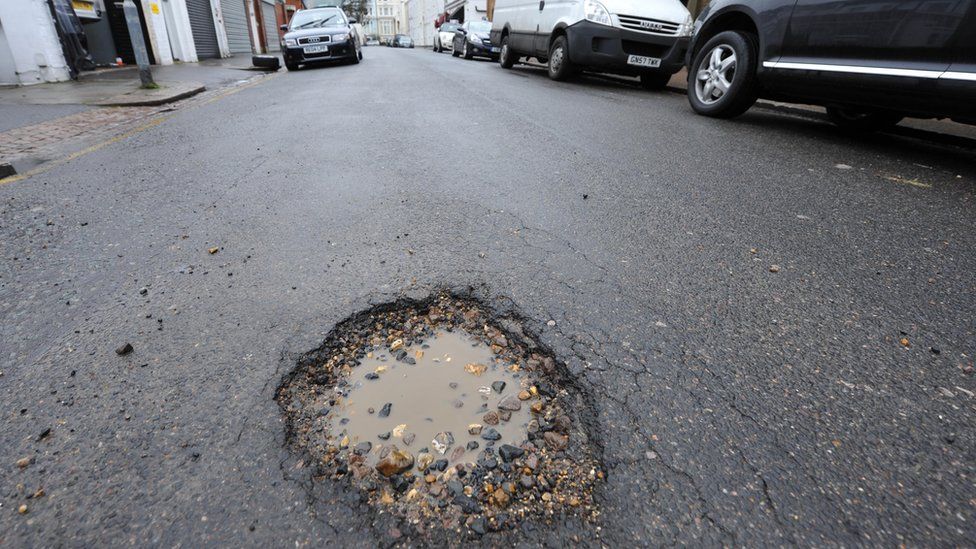 A pothole on a busy urban street