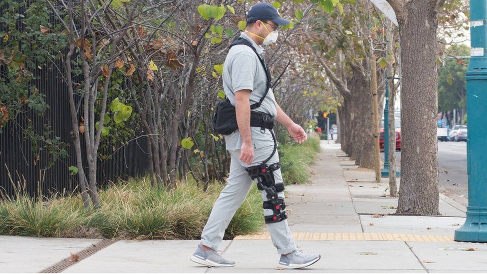 A man wearing a SuitX BoostX knee brace