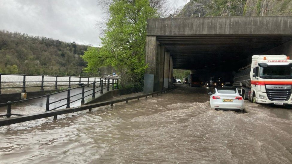 Vehicles driver through deep water on the A4 Portway near Bristol