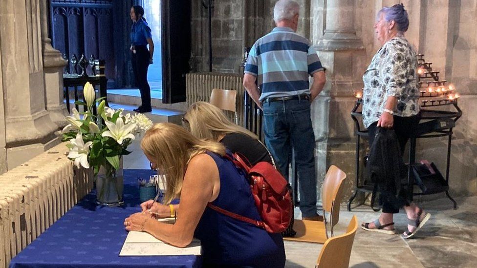 People writing in the books of condolence at the cathedral