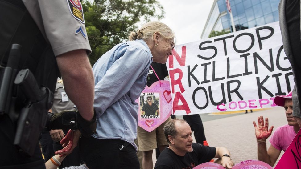 A woman is arrested during a protest outside NRA headquarters in Fairfax, Virginia, in 2016