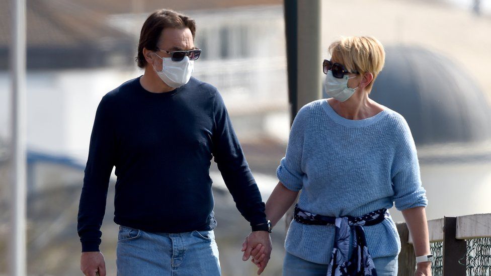 A man and a woman wearing masks in Bournemouth