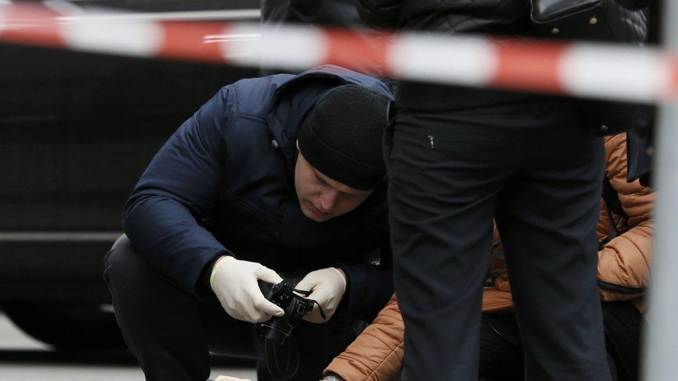 Police investigate the scene of the attack outside the Premier Palace hotel in Kiev