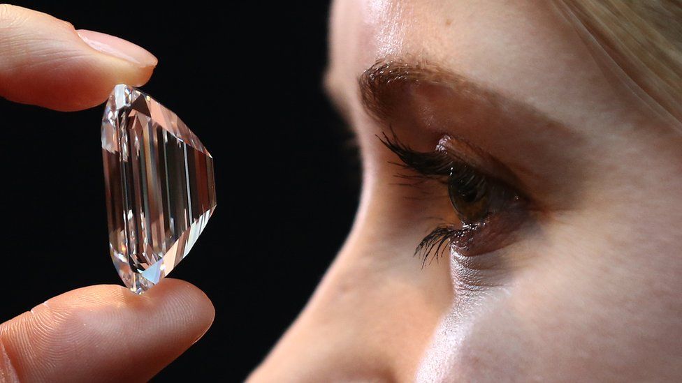 Woman staring at a 100 carat diamond