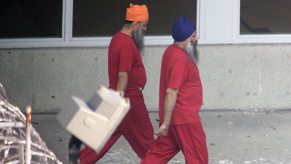 Accused Air India bombers Ajaib Singh Bagri (R) and Ripudaman Singh Malik walk together through the exercise yard at the jail where they are in custody November 1, 2004 in Vancouver, British Columbia, Canada.
