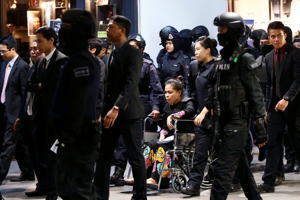 Indonesian Siti Aisyah, who is on trial for the killing of Kim Jong Nam, the estranged half-brother of North Korea"s leader, is escorted as she revisits the Kuala Lumpur International Airport 2 in Sepang, Malaysia 24 October 2017.