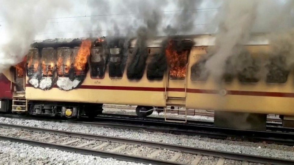 A train coach burns following a protest in Gaya, Bihar, India January 26, 2022 in this still image taken from a video.