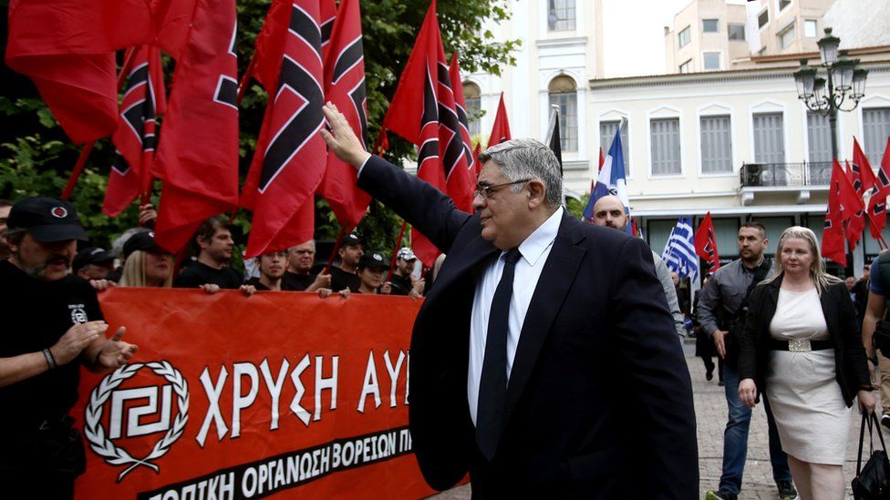 Golden Dawn leader Nikolaos Michaloliakos salutes party supporters in 2017 (file pic)