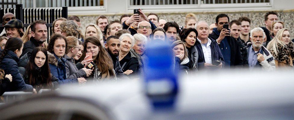 People gather at the High security courthouse, in Schiphol, Amsterdam, on March 12, 2018 for the Holleeder trial