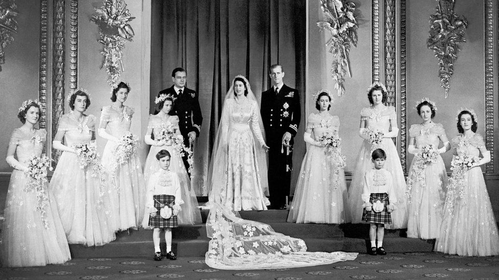 Princess Elizabeth and the Duke of Edinburgh with their eight bridesmaids in the Throne Room at Buckingham Palace.