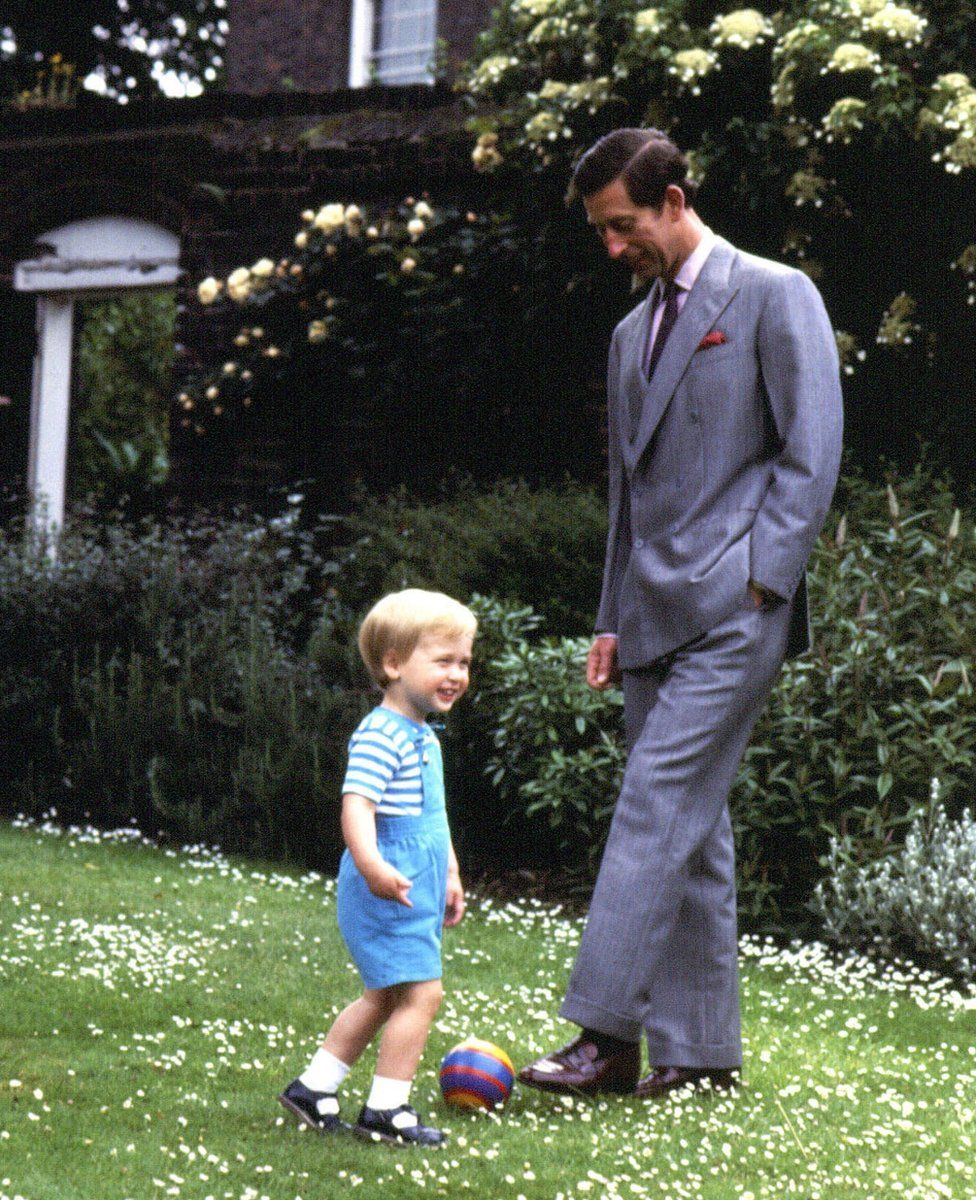 Prince of Wales and Prince William playing in the garden of Kensington Palace, London.
