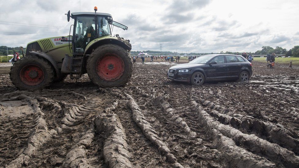 A car being towed by a tractor