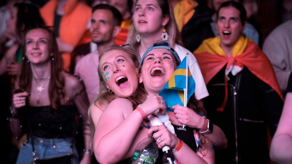 Eurovision fans enjoy the party atmosphere as they watch the Eurovision Song Contest final on a giant screen in the Eurovision Village on May 13, 2023 in Liverpool