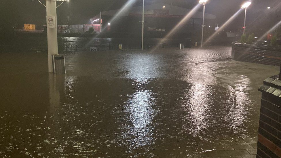 Photo taken with permission from the twitter feed of @morgannlouisee_ of flood water outside Meadowhall shopping centre, just off the M1 near Sheffield,