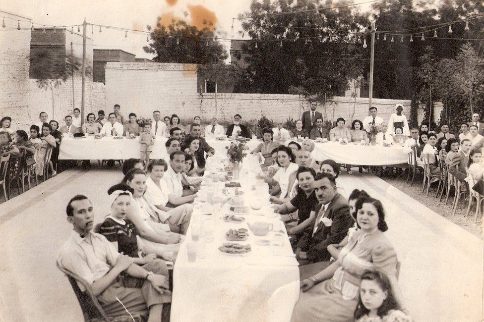 People sitting at a festival table