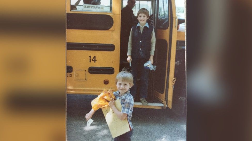 Tom Humphries and his brother with an US school bus