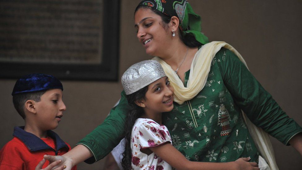Parsis greet each other after offering prayers during the Parsi New Year 'Navroze' in Mumbai on August 19, 2010. Parsis, followers of Zoroastrianism, a small religious community which exists largely in Mumbai, were exiled from Iran in the 7th century AD during religious persecution by the Muslims.