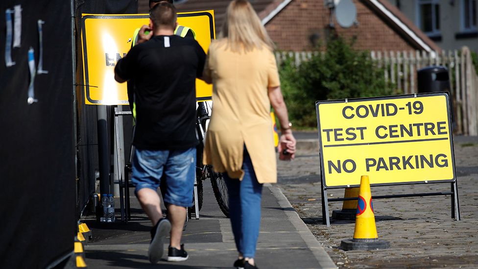 People arrive at a walk-in test facility following the outbreak of the coronavirus disease (COVID-19) in the Farnsworth area of Bolton, 15 September