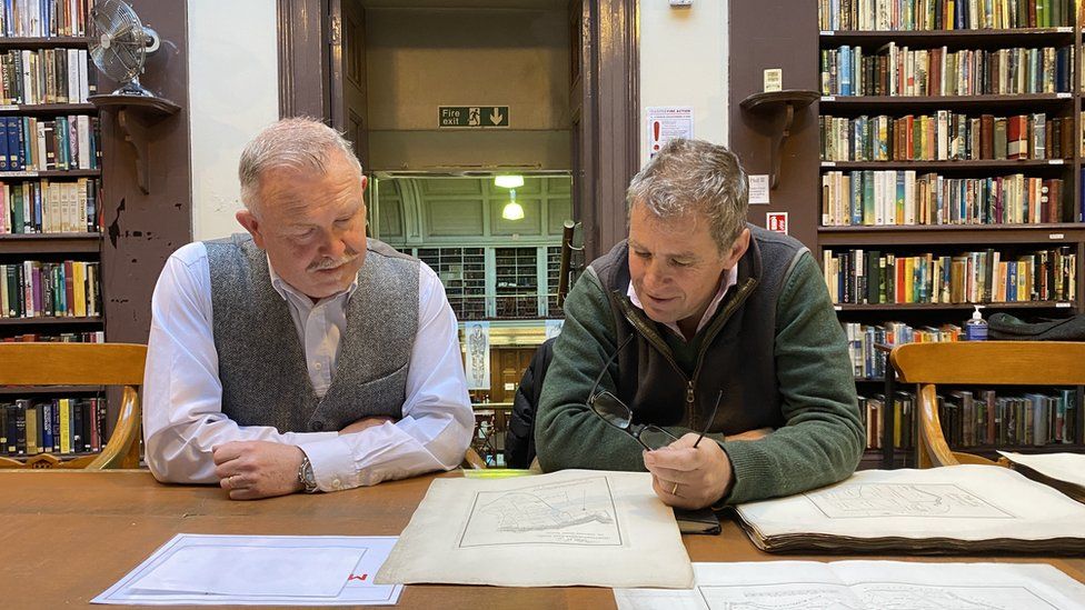 Two men Charlie Bennett and naturalist Michael Turner examining the map from 1805 in a library called the Lit and Phil in Newcastle