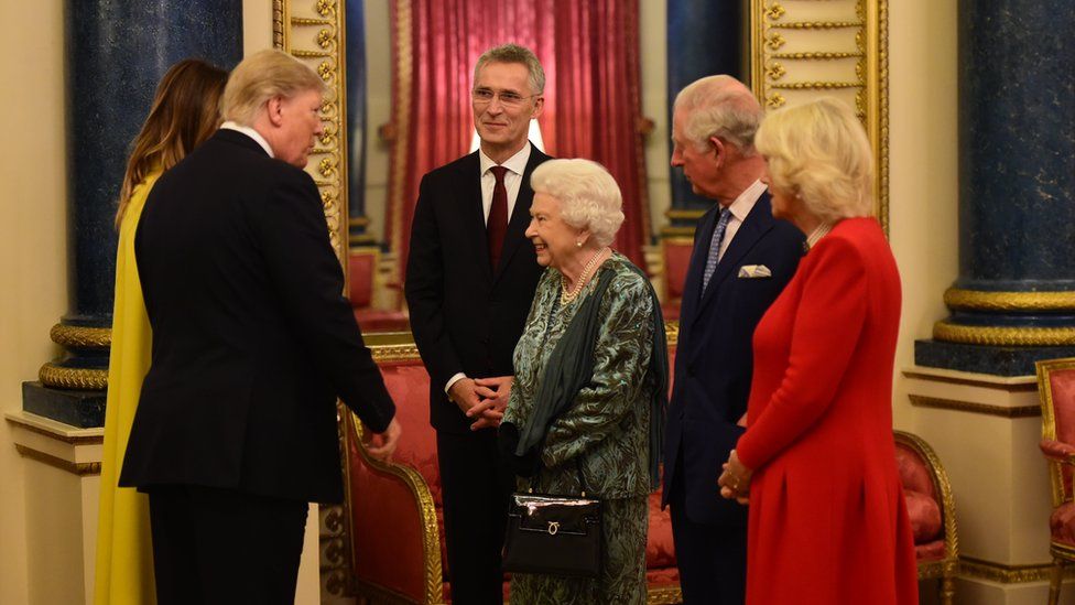 The Queen talks to US President Donald Trump and wife Melania as she hosts a reception for Nato leaders at Buckingham Palace