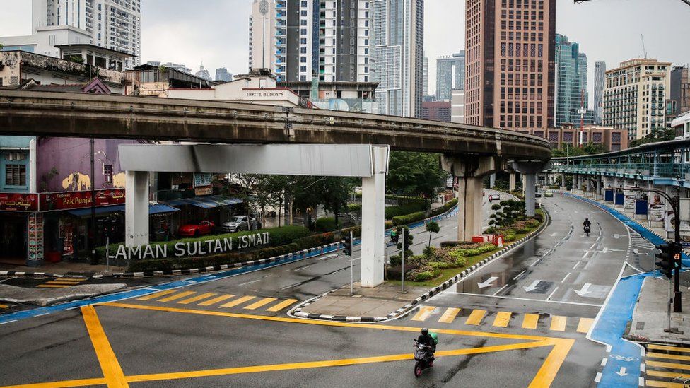 A food delivery rider is seen riding along an empty street in downtown Kuala Lumpur. Malaysia government starts to further tighten the movement control and imposes lockdown in state of Selangor and parts of Kuala Lumpur.