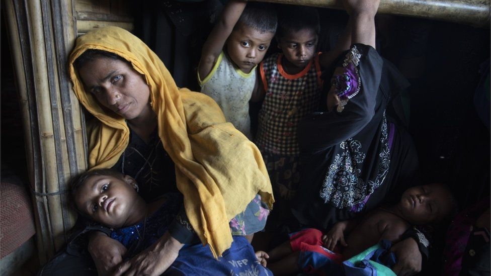 Rohingya women and children wait in line for a food distribution in Kutupalong camp on August 26, 2018 in Cox"s Bazar