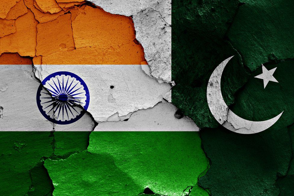 The flags of India and Pakistan painted on cracked wall