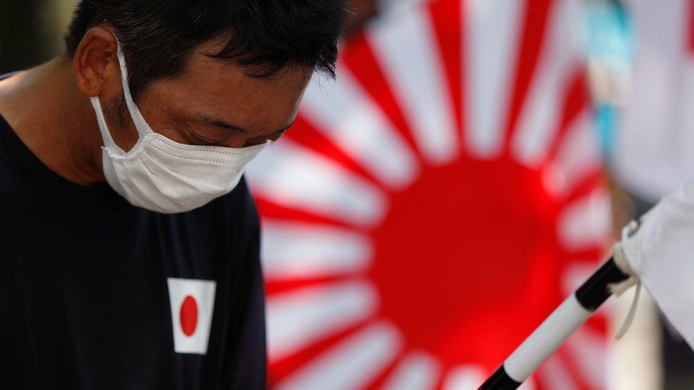 A man pays a silent tribute during his visit to Yasukuni Shrine