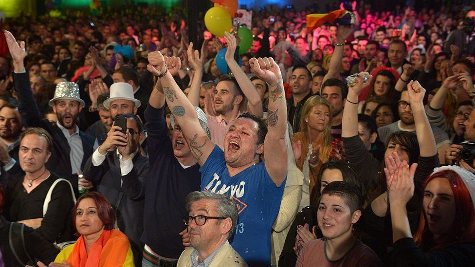 People celebrate in Saint George's Square after the Maltese parliament approved a civil unions bill in Valletta on 14 April 2014