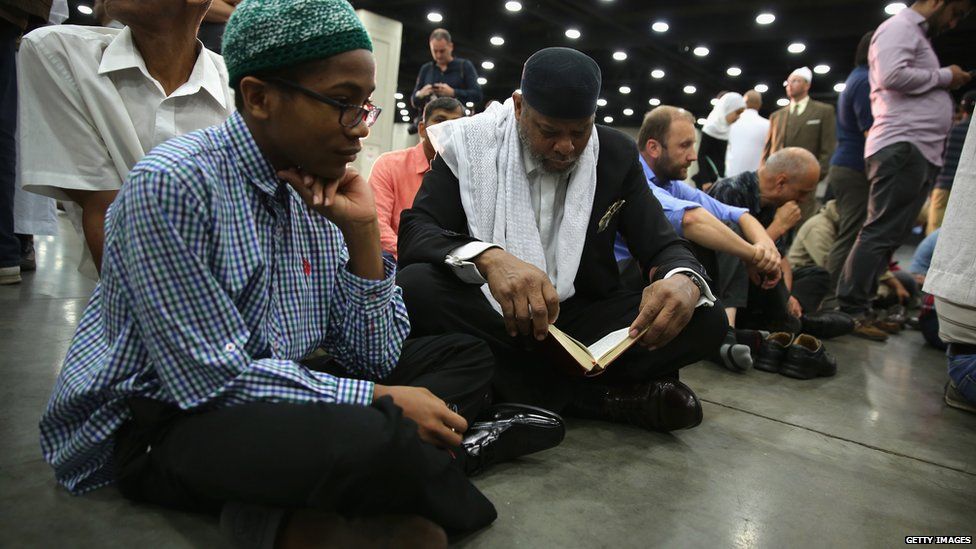 Muslim worshippers read from the Quran at the prayer service in Louisville