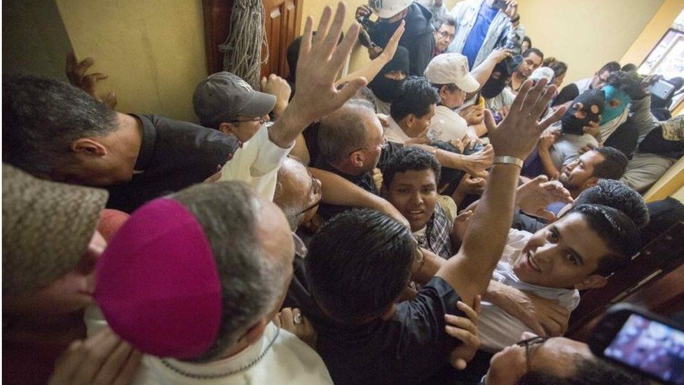 Bishop Silvio Baez (L) calls for calm while a group of government supporters attack several bishops and journalists after violently breaking into the basilica of San Sebastian, in Diriamba, Nicaragua, 09 July 2018.