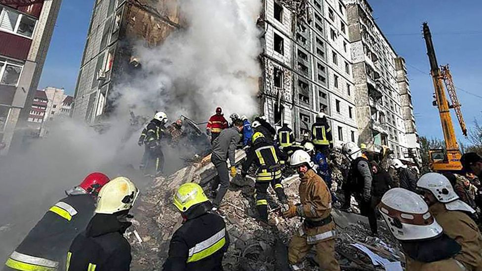 Rescuers work to clear rubble from a collapsed building