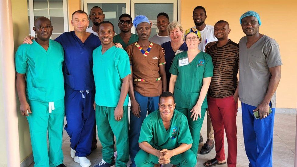 A group of volunteers from the NHS and Ghanaian health professionals inside a hospital