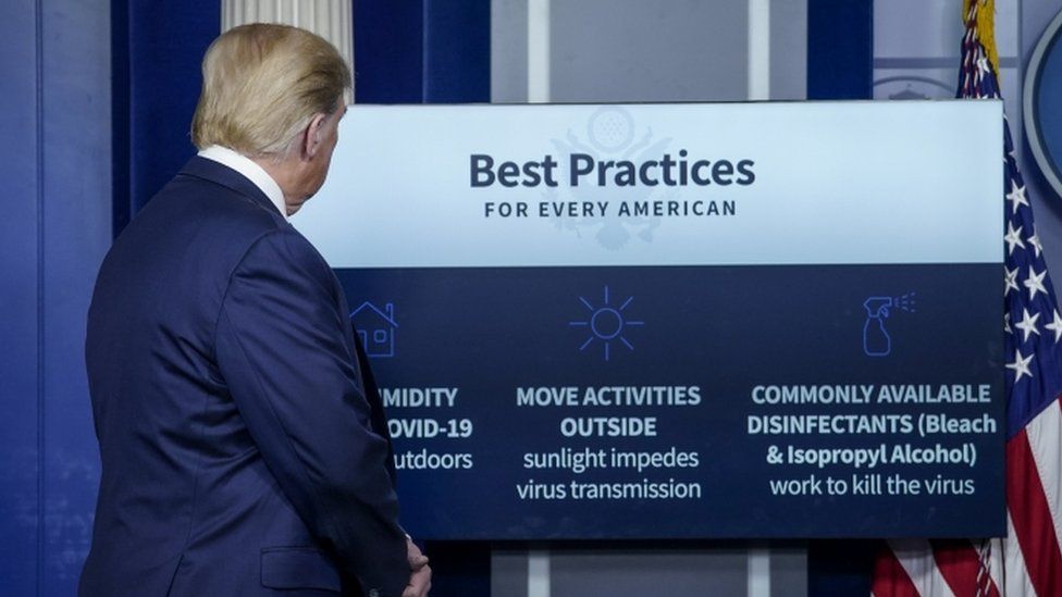 Donald Trump with a list of possible Covid-19 treatments at the White House briefing, 23 April 2020